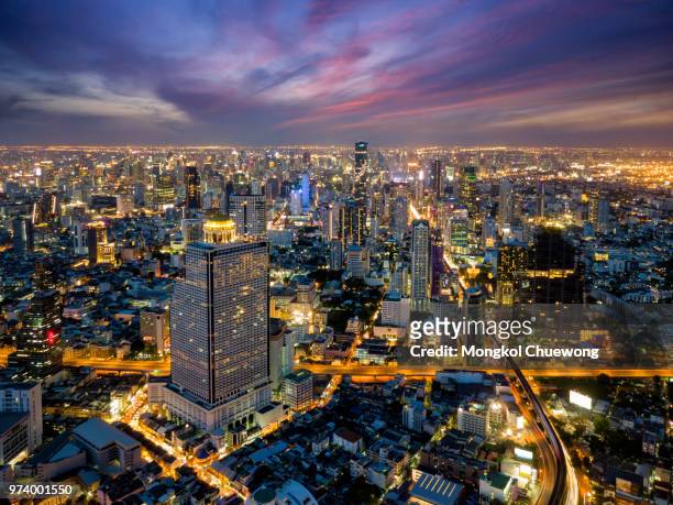 aerial view of bangkok skyline and skyscraper with bts skytrain bangkok downtown. panorama of sathorn and silom business district bangkok thailand at night. - silom foto e immagini stock