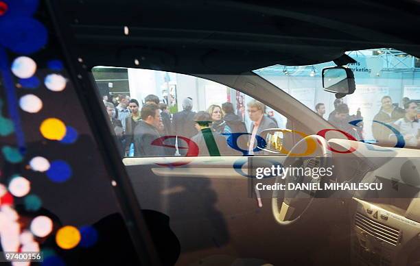 Google logo is reflected in a window of a car equiped with special cameras, used to photograph whole streets, can be seen on the Google street-view...