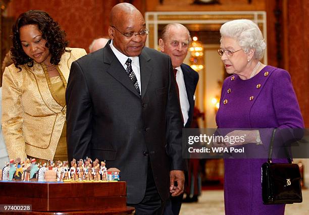 Britain's Queen Elizabeth II , Prince Philip, the Duke of Edinburgh and President of South Africa Jacob Zuma with his wife Tobeka Madiba Zuma look at...