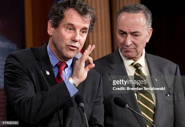 Senator Charles Schumer listens as Sen. Sherrod Brown speaks during a news conference on Capitol Hill March 3, 2010 in Washington, DC. Sen. Charles...