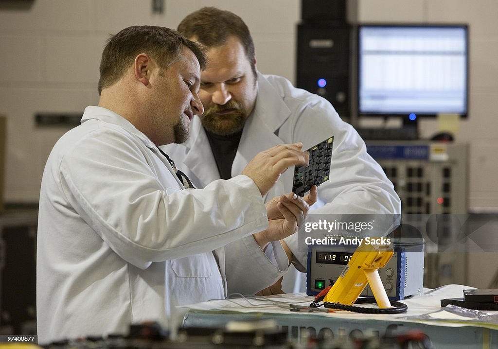 Technicians at work in auto battery lab