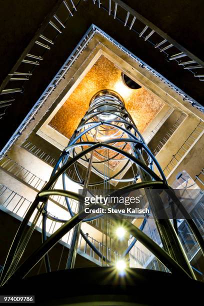 modern elevator inside astronomical clock tower, prague, czech republic - horloge stock-fotos und bilder
