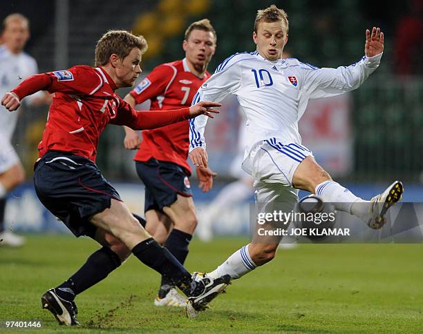 Tom Hoegli of Norway and Slovakia's Marek Sapara fight for a ball during their friendly match between Slovakia and Norway in Zilina on March 03,2010....