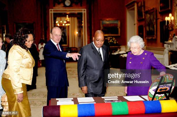 Queen Elizabeth ll and Prince Philip, Duke of Edinburgh show South African President Jacob Zuma and wife Thobeka Madiba Zuma an exhibition of South...
