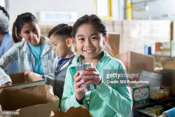 adorable little girl in food bank - filipino girl stock pictures, royalty-free photos & images