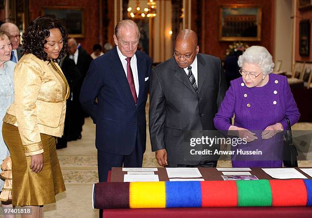 Queen Elizabeth ll and Prince Philip, Duke of Edinburgh show South African President Jacob Zuma and wife Thobeka Madiba Zuma an exhibition of South...