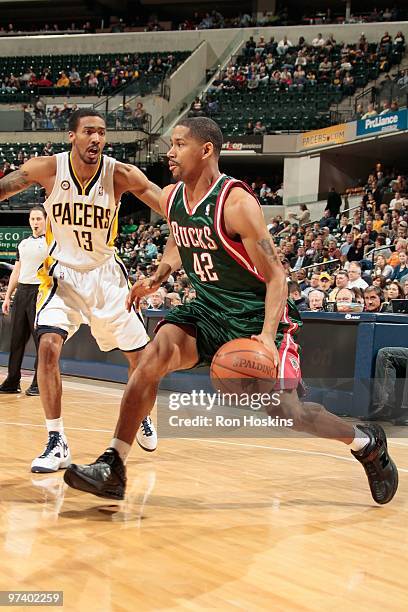 Charlie Bell of the Milwaukee Bucks drives against Luther Head of the Indiana Pacers during the game on February 25, 2010 at Conseco Fieldhouse in...