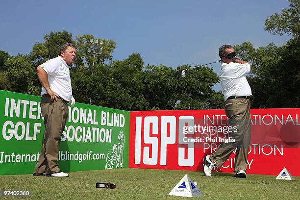 Ian Woosnam of Wales watches as Sam Torrance of Scotland plays blindfolded prior to the start of the Aberdeen Brunei Senior Masters played on March...