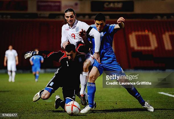 Andy Carroll of England battles for the ball with Asterios Giakoumis and Kyriakos Papadopoulos of Greece during the UEFA Under 21 Championship...