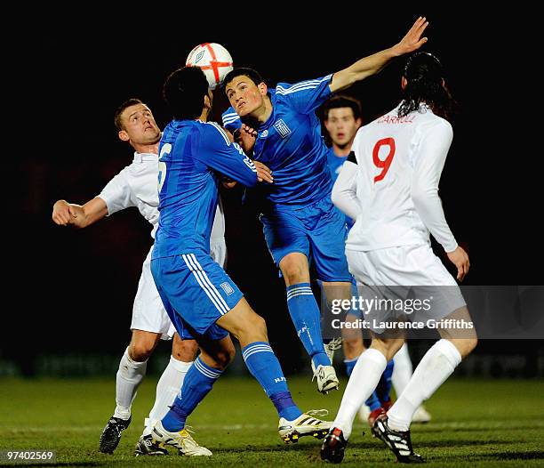 Kyriakos Papadopoulos of Greece battles with Lee Cattermole of England during the UEFA Under 21 Championship Qualifying match between England and...