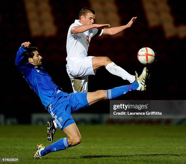 Ioannis Papadopoulos of Greece battles with Lee Cattermole of England during the UEFA Under 21 Championship Qualifying match between England and...