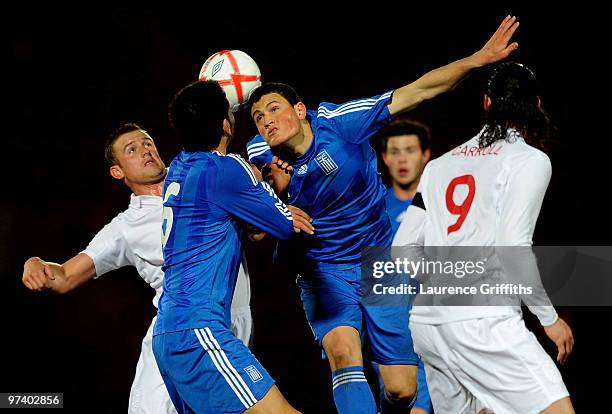 Kyriakos Papadopoulos of Greece battles with Lee Cattermole of England during the UEFA Under 21 Championship Qualifying match between England and...