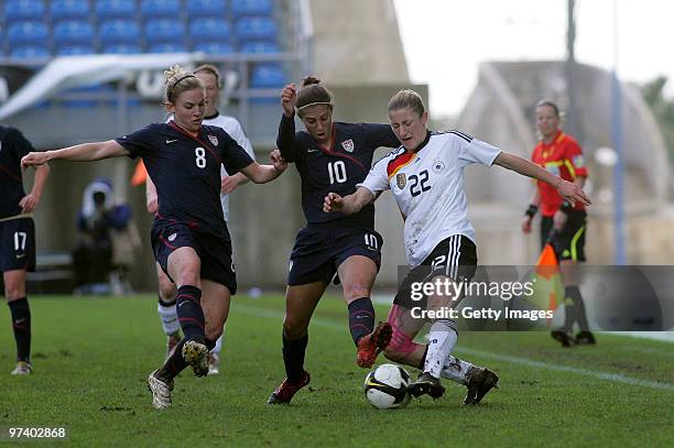 Bianca Schmidt of Germany, Amy Rodriguez and Carli LLoyd of USA battle for the ball during the Women Algarve Cup match between Germany and USA on...