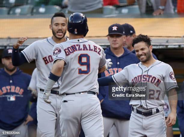 Marwin Gonzalez of the Houston Astros is congratulated by Jose Altuve and George Springer after hitting a home run in the second inning against the...