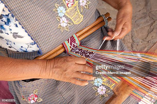 woman using backstrap loop to weave belt  - belt loop stock pictures, royalty-free photos & images