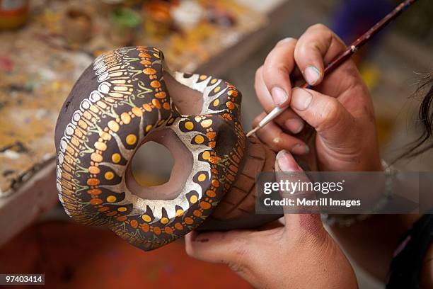 hands painting skull "alebrije" made of copal wood - alebrije stock pictures, royalty-free photos & images