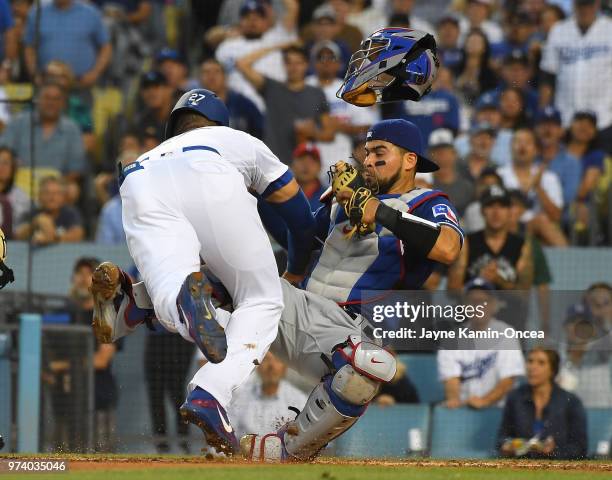 Matt Kemp of the Los Angeles Dodgers is out at the plate as he collides with Robinson Chirinos of the Texas Rangers in the third inning at Dodger...