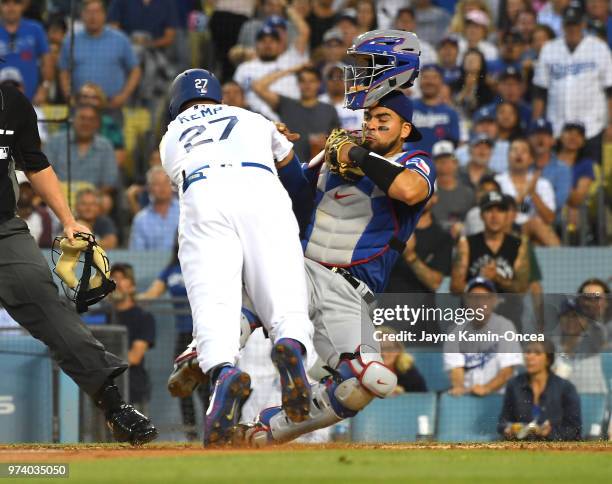 Matt Kemp of the Los Angeles Dodgers is out at the plate as he collides with Robinson Chirinos of the Texas Rangers in the third inning at Dodger...