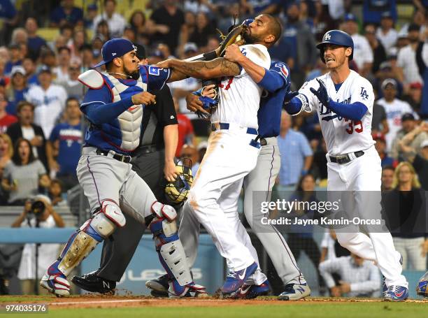 Cole Hamels of the Texas Rangers and Cody Bellinger of the Los Angeles Dodgers try to hold back Matt Kemp of the Los Angeles Dodgers and Robinson...