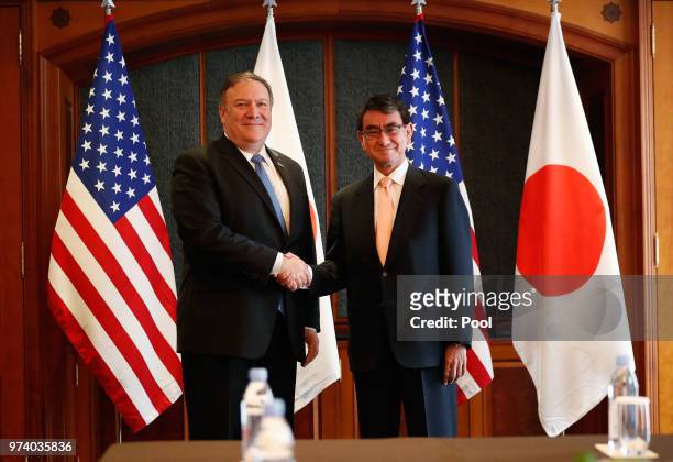 Secretary of State Mike Pompeo shakes hands with Japanese Foreign Minister Taro Kono before their meeting at South Korea's foreign ministry on June...