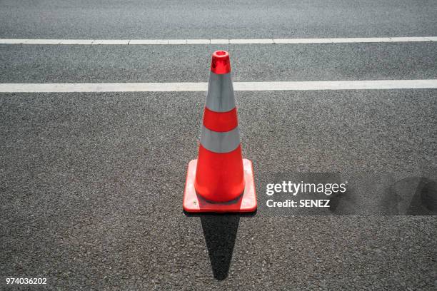 traffic cone,an image of cautions on asphalt road - traffic cone 個照片及圖片檔