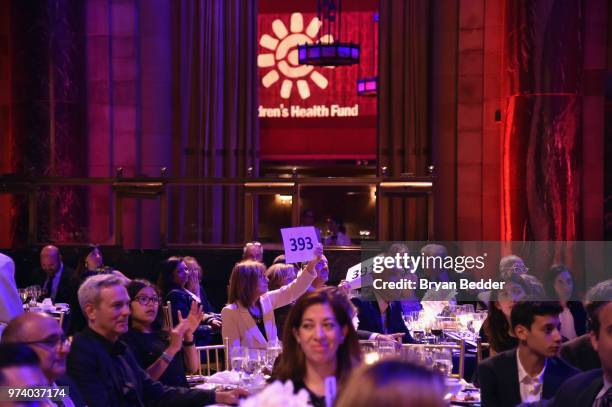 Guests participate in an auction during the Children's Health Fund 2018 Annual Benefit at Cipriani 42nd Street on June 13, 2018 in New York City.