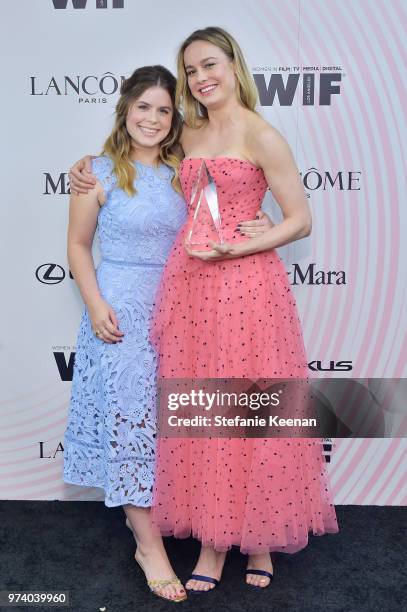 Jessie Ennis and honoree Brie Larson pose with The Crystal Award for Excellence in Film during the Women In Film 2018 Crystal + Lucy Awards presented...