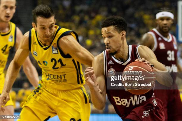 Jared Cunningham of Bayern Muenchen competes with Spencer Butterfield of ALBA Berlin during the fourth play-off game of the German Basketball...