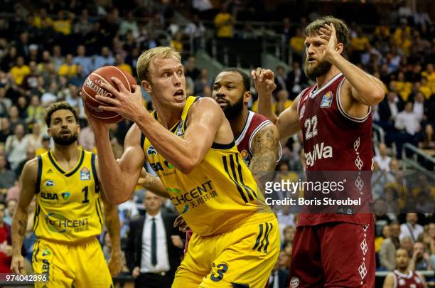 Luke Sikma of ALBA Berlin competes with Danilo Barthel of Bayern Muenchen during the fourth play-off game of the German Basketball Bundesliga finals...