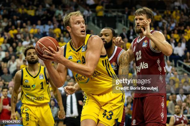 Luke Sikma of ALBA Berlin competes with Danilo Barthel of Bayern Muenchen during the fourth play-off game of the German Basketball Bundesliga finals...