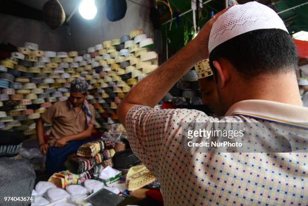 Bangladeshi Muslims buy Islamic cap for prayer ahead of Eid al-Fitr festival, during the holy month of Ramadan in Dhaka, Bangladesh, on June 13,...