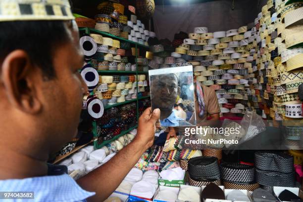 Bangladeshi Muslims buy Islamic cap for prayer ahead of Eid al-Fitr festival, during the holy month of Ramadan in Dhaka, Bangladesh, on June 13,...