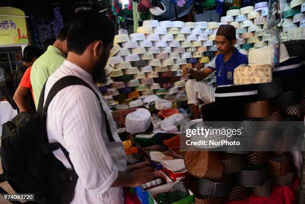 Bangladeshi Muslims buy Islamic cap for prayer ahead of Eid al-Fitr festival, during the holy month of Ramadan in Dhaka, Bangladesh, on June 13,...