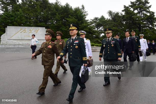 In this handout image provided by South Korean Defense Ministry, South Korean Major Gen. Kim Do-gyun is escorted by a North Korean officer after...