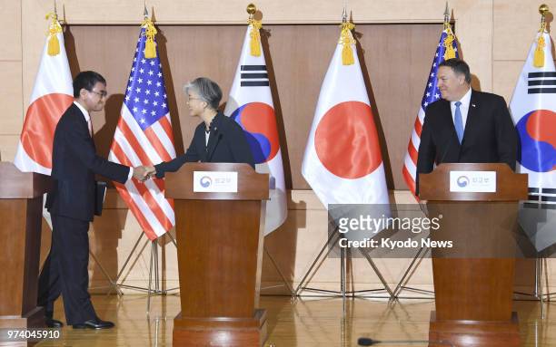 Japanese Foreign Minister Taro Kono shakes hands with South Korean Foreign Minister Kang Kyung Wha, as U.S. Secretary of State Mike Pompeo looks on...