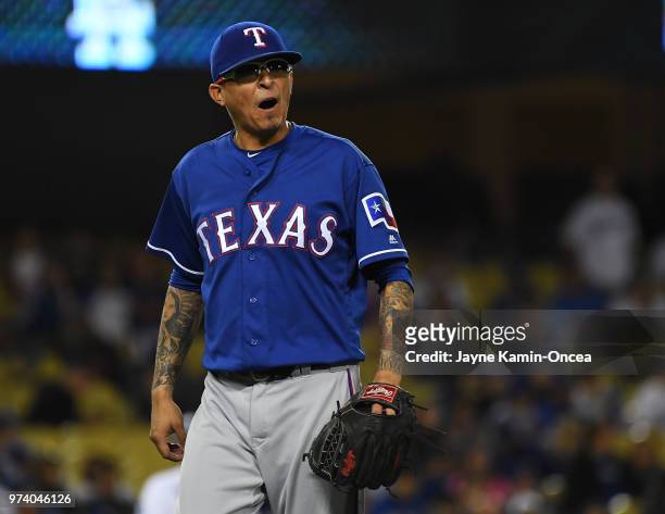 Jesse Chavez of the Texas Rangers reacts after he is pulled from the eleventh inning of the game Los Angeles Dodgers at Dodger Stadium on June 13,...
