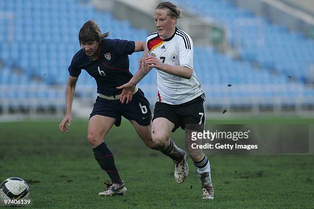 Melanie Behringer of Germany and LePiebet of USA battle for the ball during the Women Algarve Cup match between Germany and USA on March 3, 2010 in...