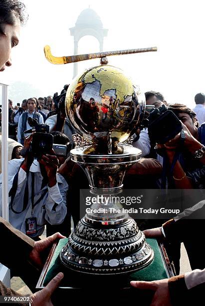 Photographers take pictures of the FIH Hockey World Cup 2010 trophy during a photo shoot in front of India Gate in New Delhi on February 26, 2010.