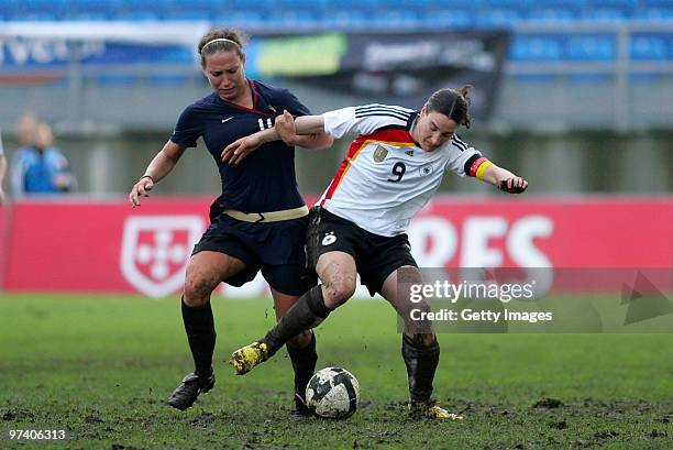Birgit Prinz of Germany and Lauren Cheney of USA battle for the ball during the Women Algarve Cup match between Germany and USA on March 3, 2010 in...
