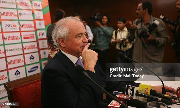 International Hockey Federation President Leandro Negre and FIH spokesman Arjen Meijer watch an almost empty press conference venue after journalists...