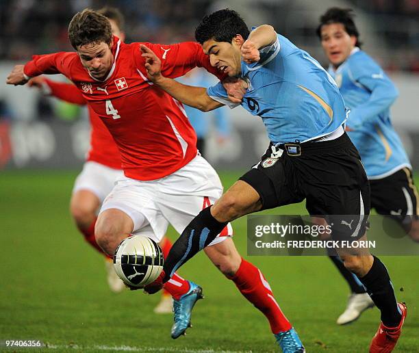 Switzerland's Jonathan Rossini vies with Uruguay's Luis Suarez during the World Cup 2010 friendly football match Switzerland vs Uruguay at AFG Arena...