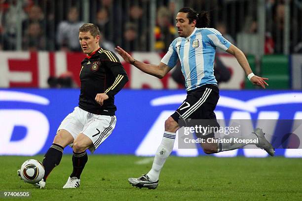 Jonás Gutiérrez of Argentina challenges Bastian Schweinsteiger of Germany during the International Friendly match between Germany and Argentina at...