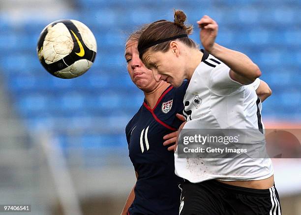 Sonja Fuss of Germany and Lauren Cheney of USA battle for the ball during the Women Algarve Cup match between Germany and USA on March 3, 2010 in...