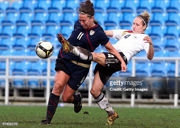 Babett Peter of Germany and Lauren Cheney of USA battle for the ball during the Women Algarve Cup match between Germany and USA on March 3, 2010 in...