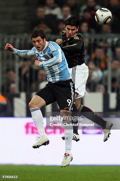 Gonzalo Higuain of Argentina and Serdar Tasci of Germany go up for a header during the International Friendly match between Germany and Argentina at...