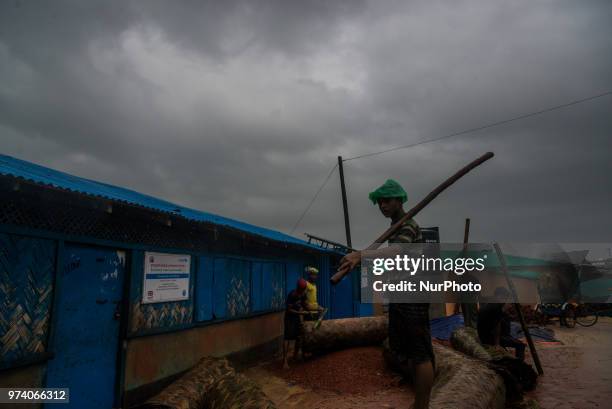 People at work in the flooded rohingya makeshift shelterr at kutupalong in Coxs Bazar, Bangladesh on June 13, 2018.