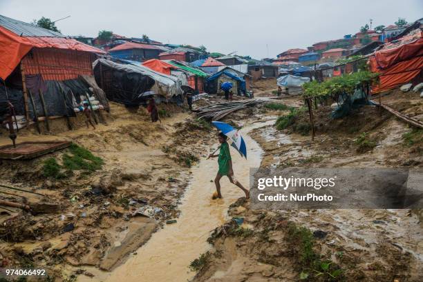 Rohingya boy is walking on the canel nside the kutupalong makeshift shelter in Coxs Bazar, Bangladesh on June 13, 2018.