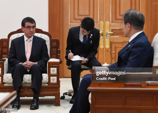 South Korean President Moon Jae-in talks with Japanese Foreign Minister Taro Kono during their meeting at presidential blue houes on June 14, 2018 in...
