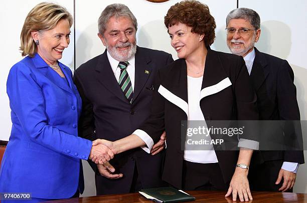 Secretary of State Hillary Rodham Clinton shakes hands with Dilma Roussef Brazil's chief of Staff as Brazilian President Luiz Inacio Lula da Silva...