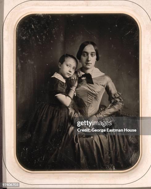 Portrait of a young girl, the photographe's daughter, as she leans on the shoulder of an unidentified woman, early 1850s.